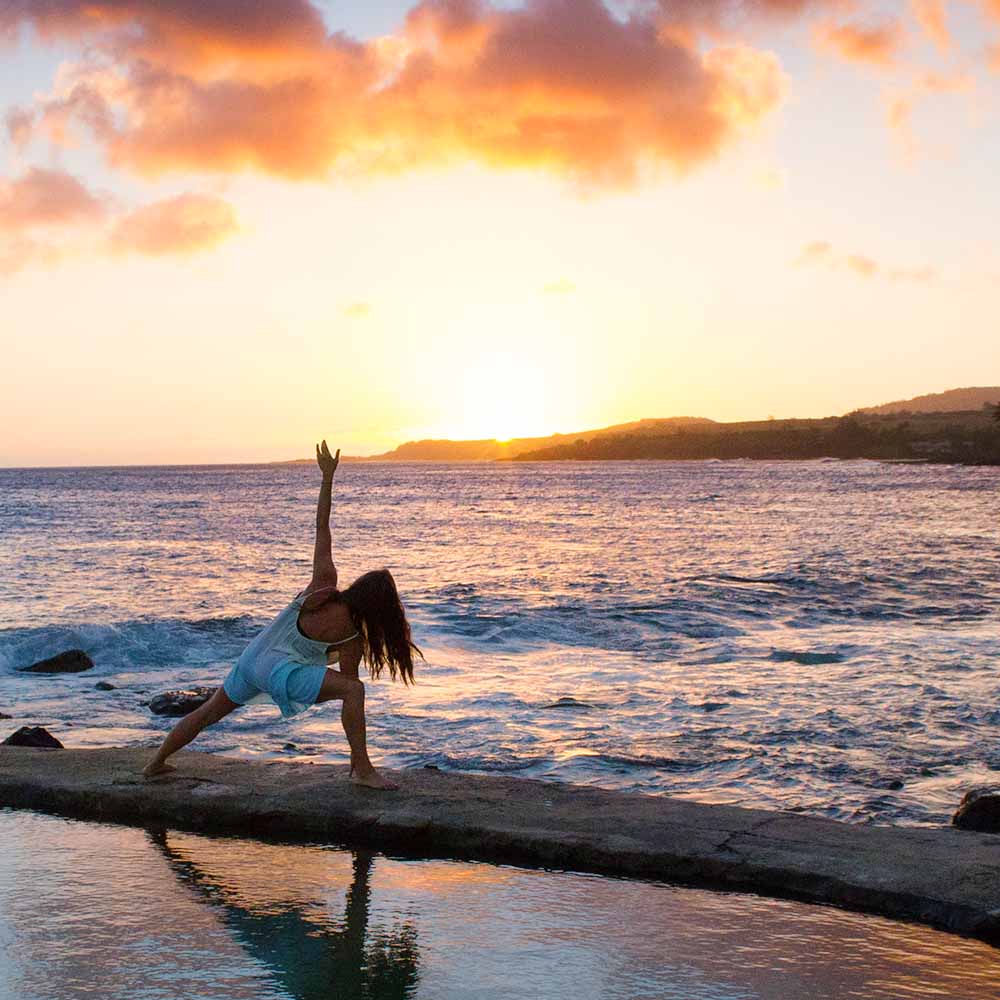 yoga at sunrise by the coast